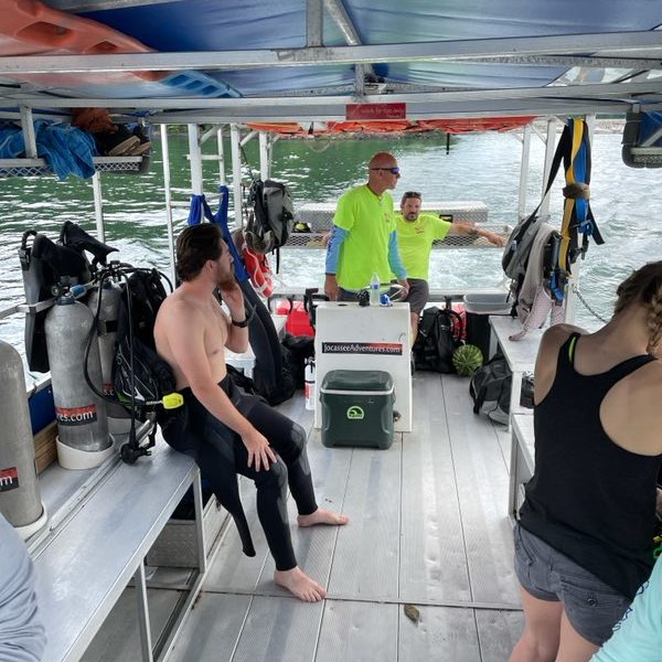 A group of people preparing to dive on a boat